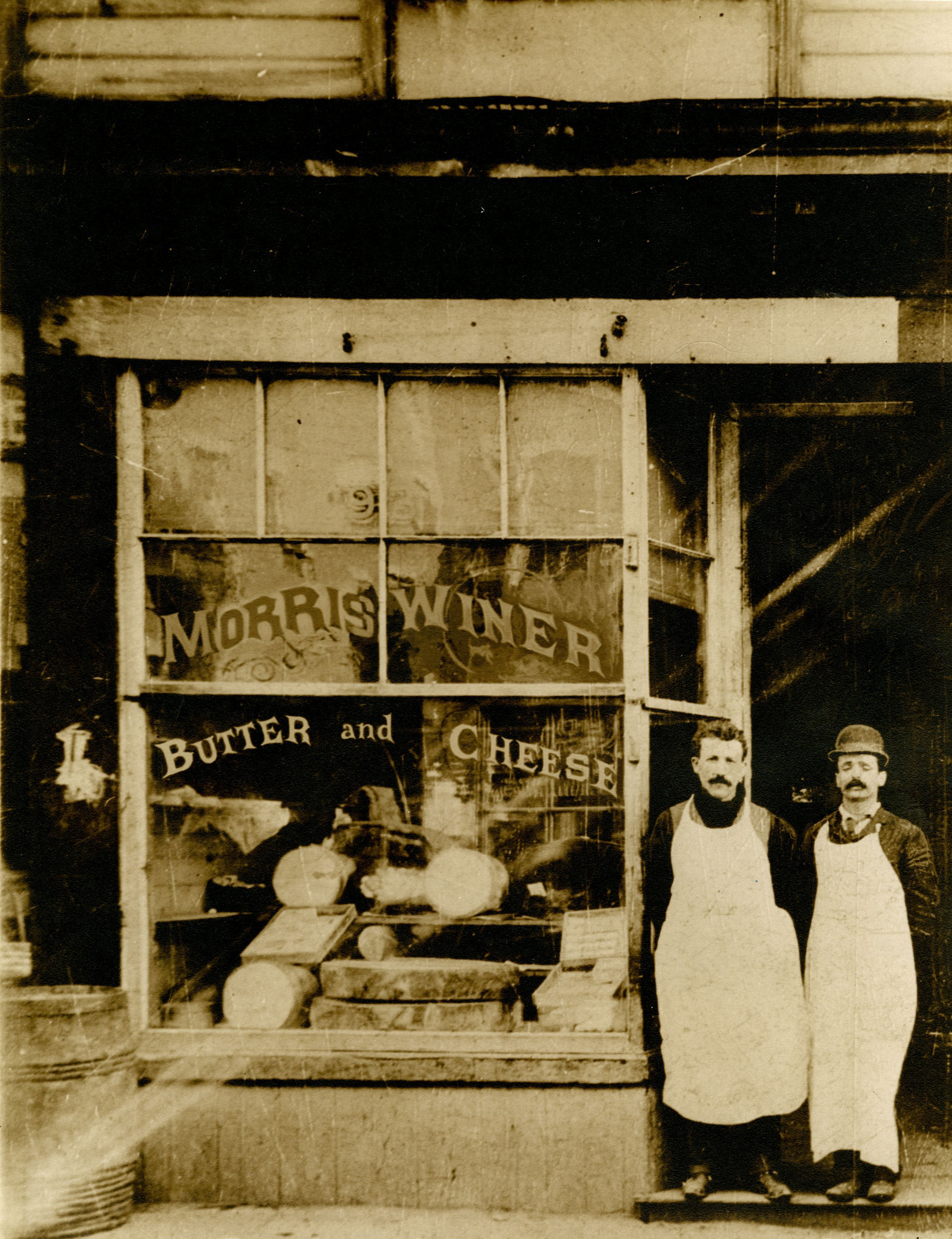 Morris Winer (left), likely with his brother Samuel, outside his storefront, circa 1895. 