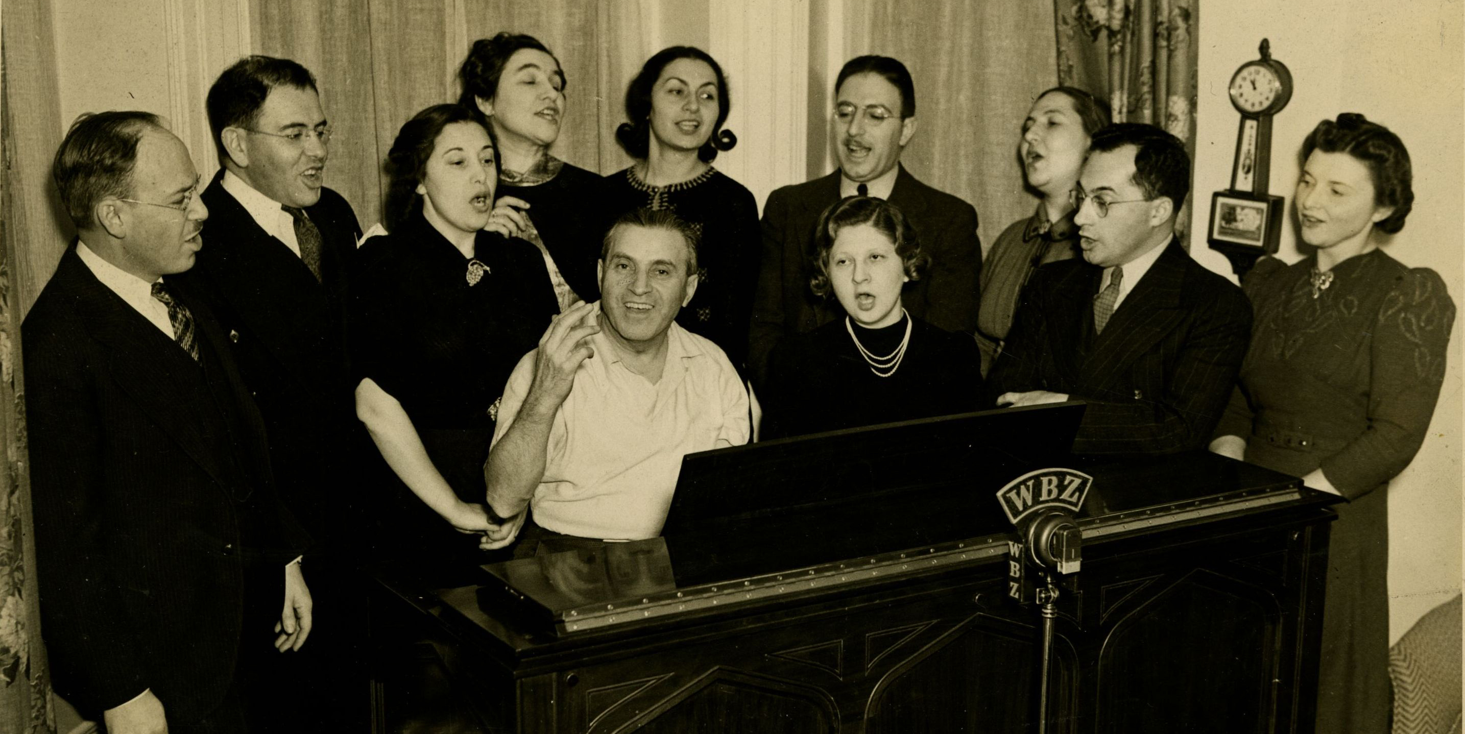 Group singing around a piano