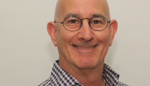 Image of scholar Benjy Maor wearing glasses and a checkered button up shirt.