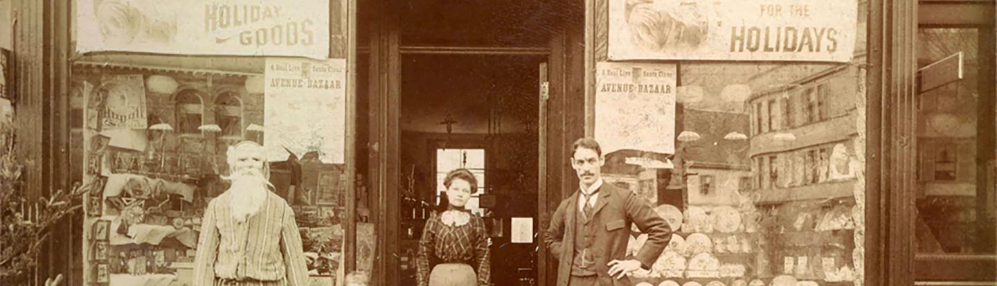 Black and white photograph of family outside storefront
